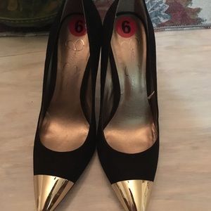 Black faux suede high heels with gold metal toe